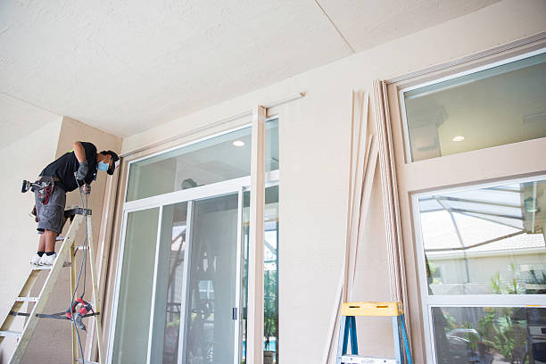 Contractor installing hurricane shutters.RM Property Maintenance