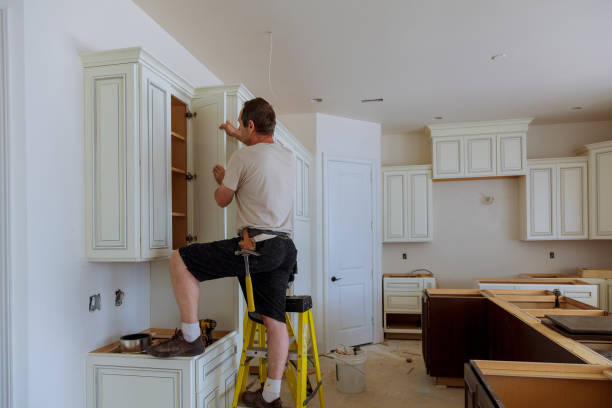 Man installing kitchen cabinets door installation of kitchen Property Maintenance