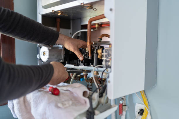 Technician Repairing Natural Gas Combi Boiler At Home Property Maintenance